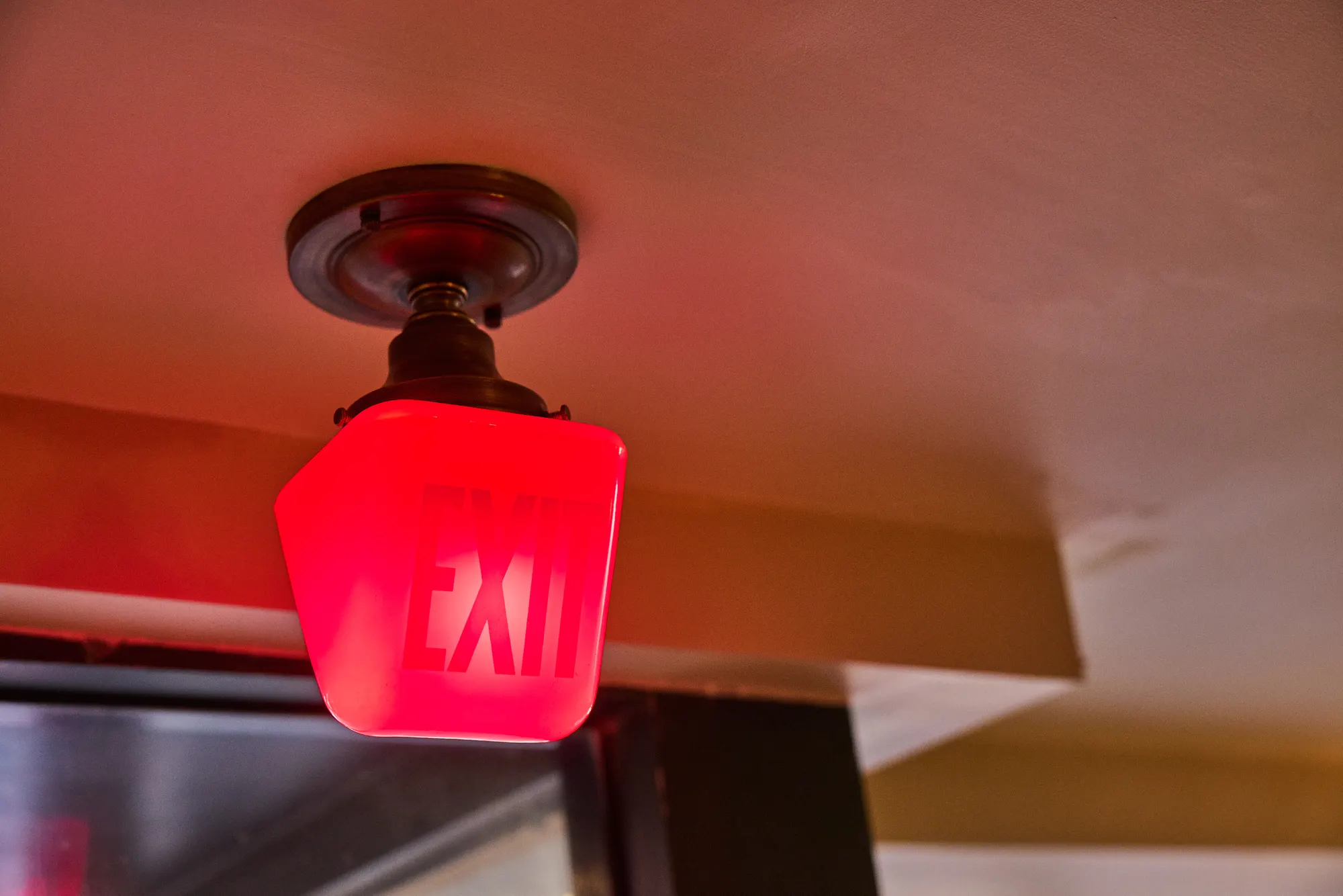 A red glass exit light above the door.