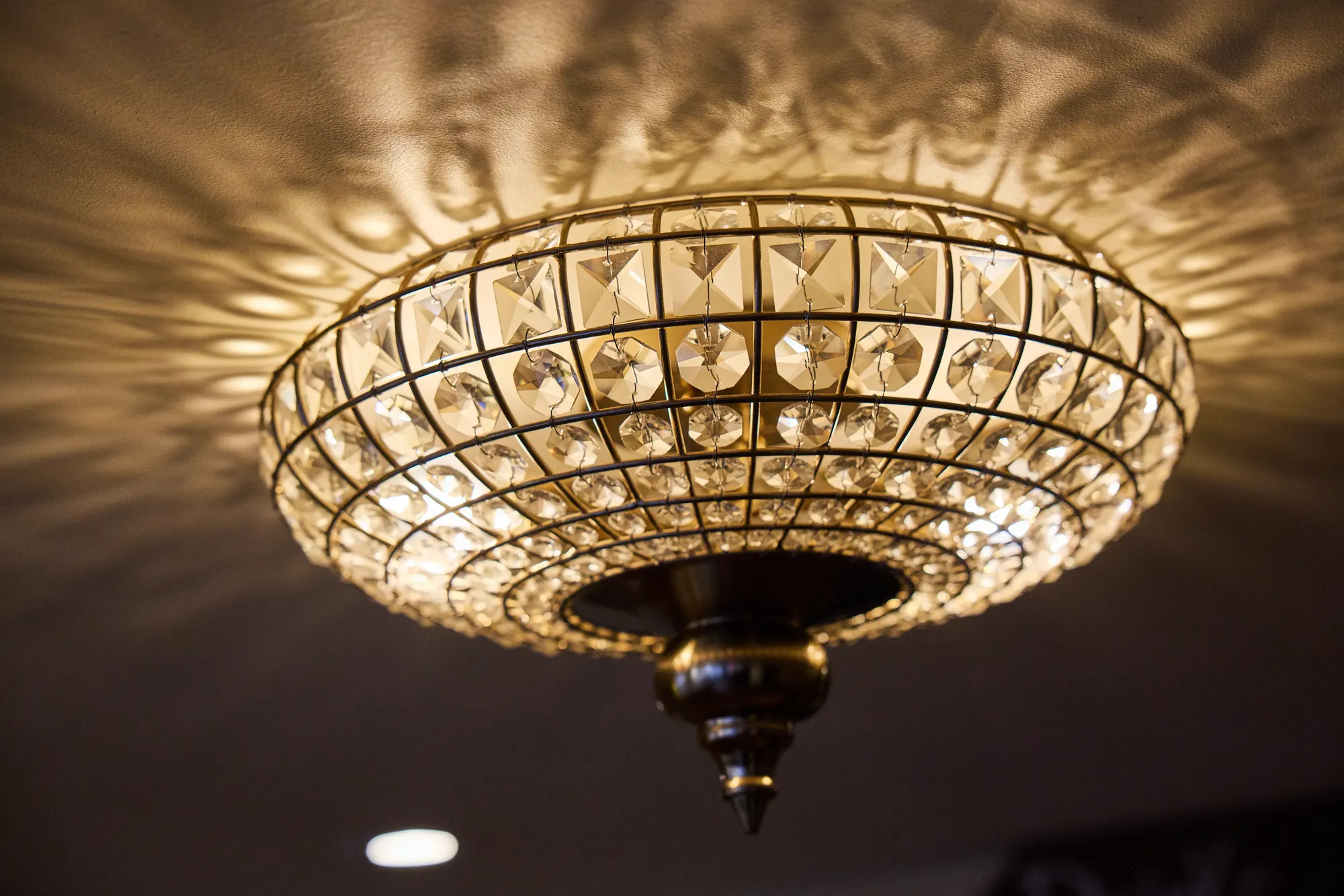 A crystal ceiling fixture casting a pattern of light across the ceiling.