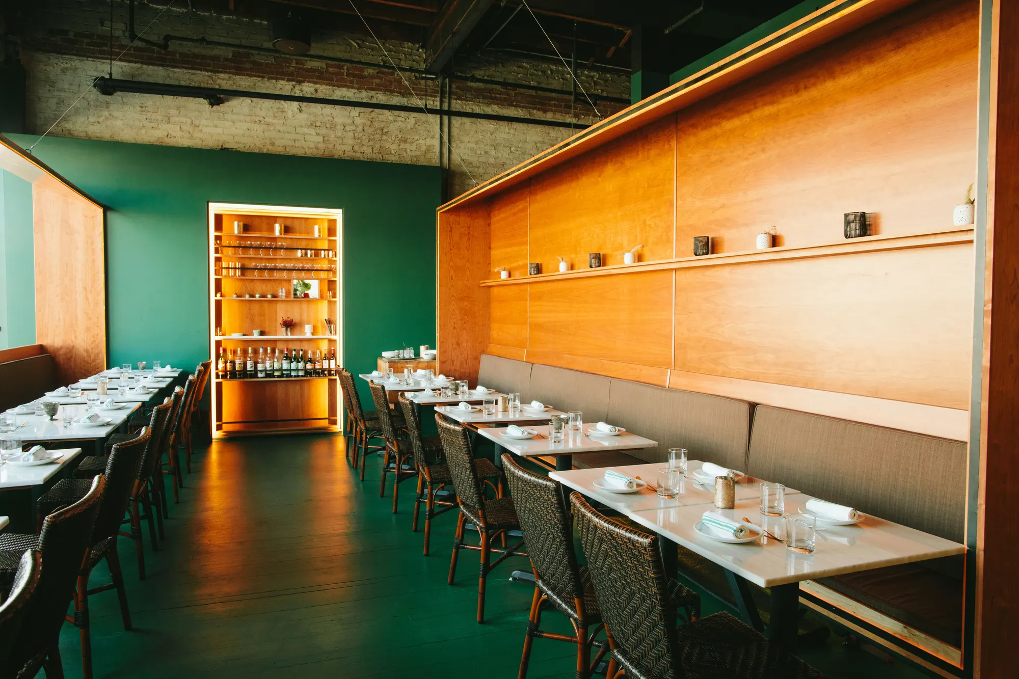 The dining room at Fat Hen, banquette seating against timber panelling