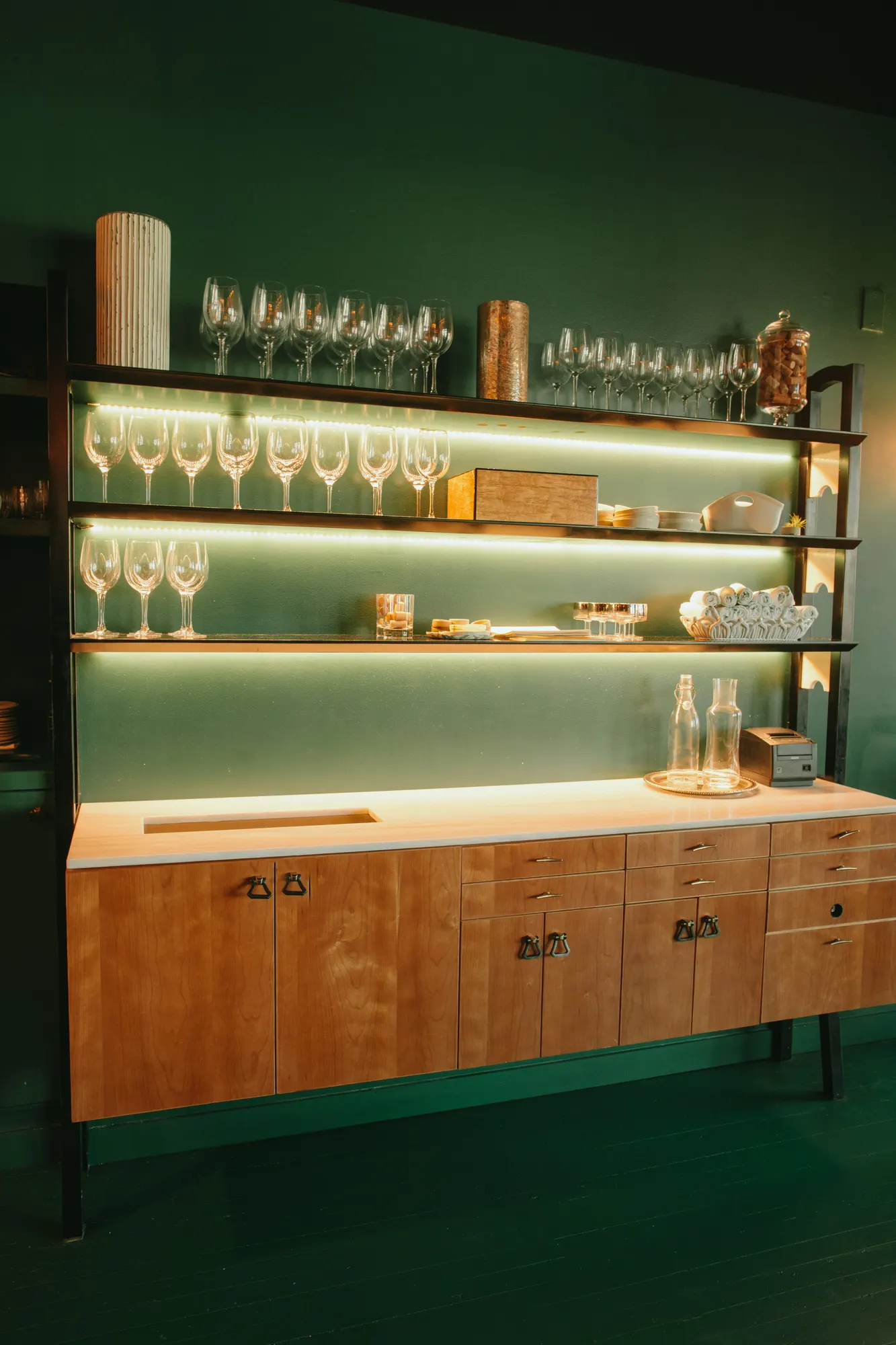 A run of cabinets under the shelving, with the working surface kept clear.