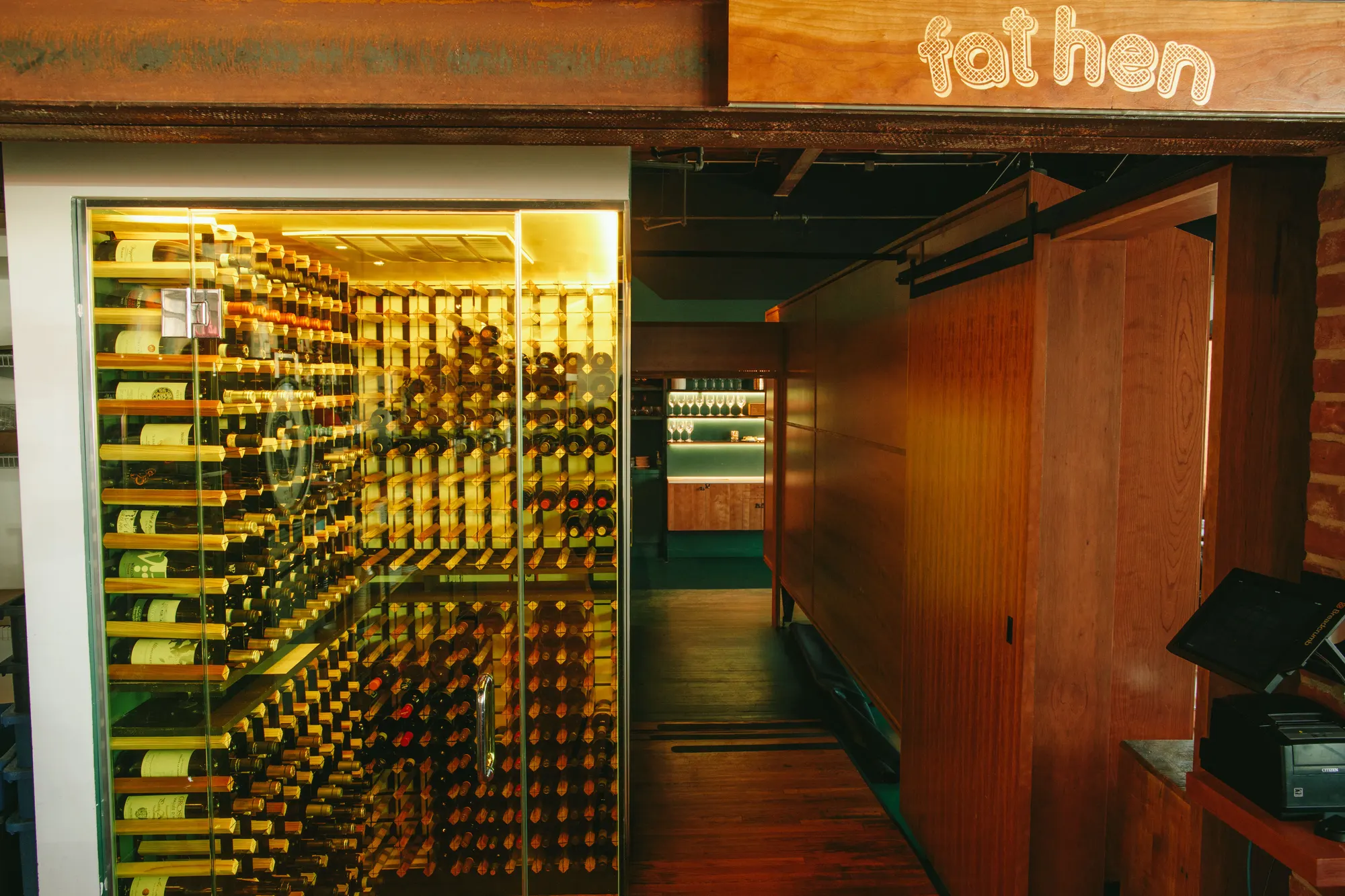 Bottles racked floor to ceiling in the room off the dining room.