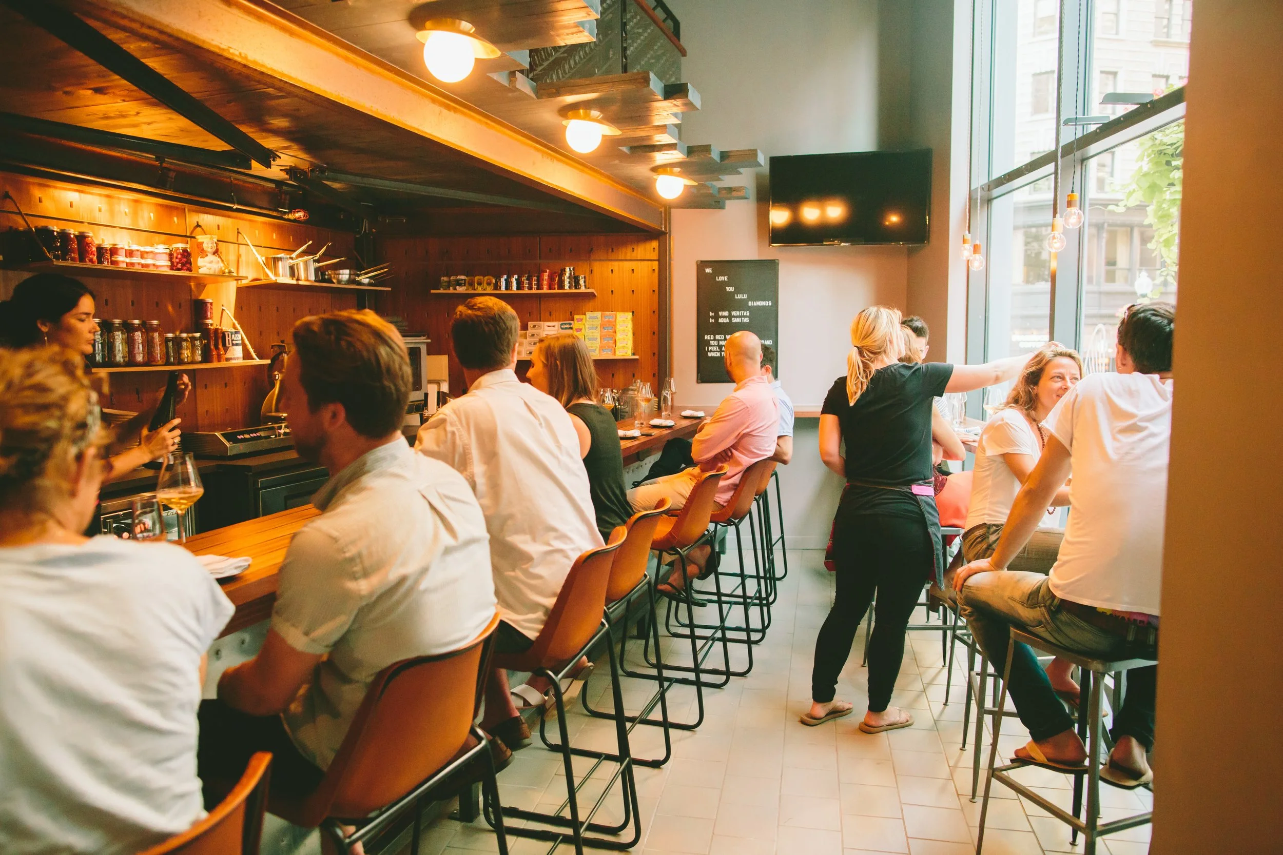 Every stool taken along the bar, and guests at high tables by the street windows.