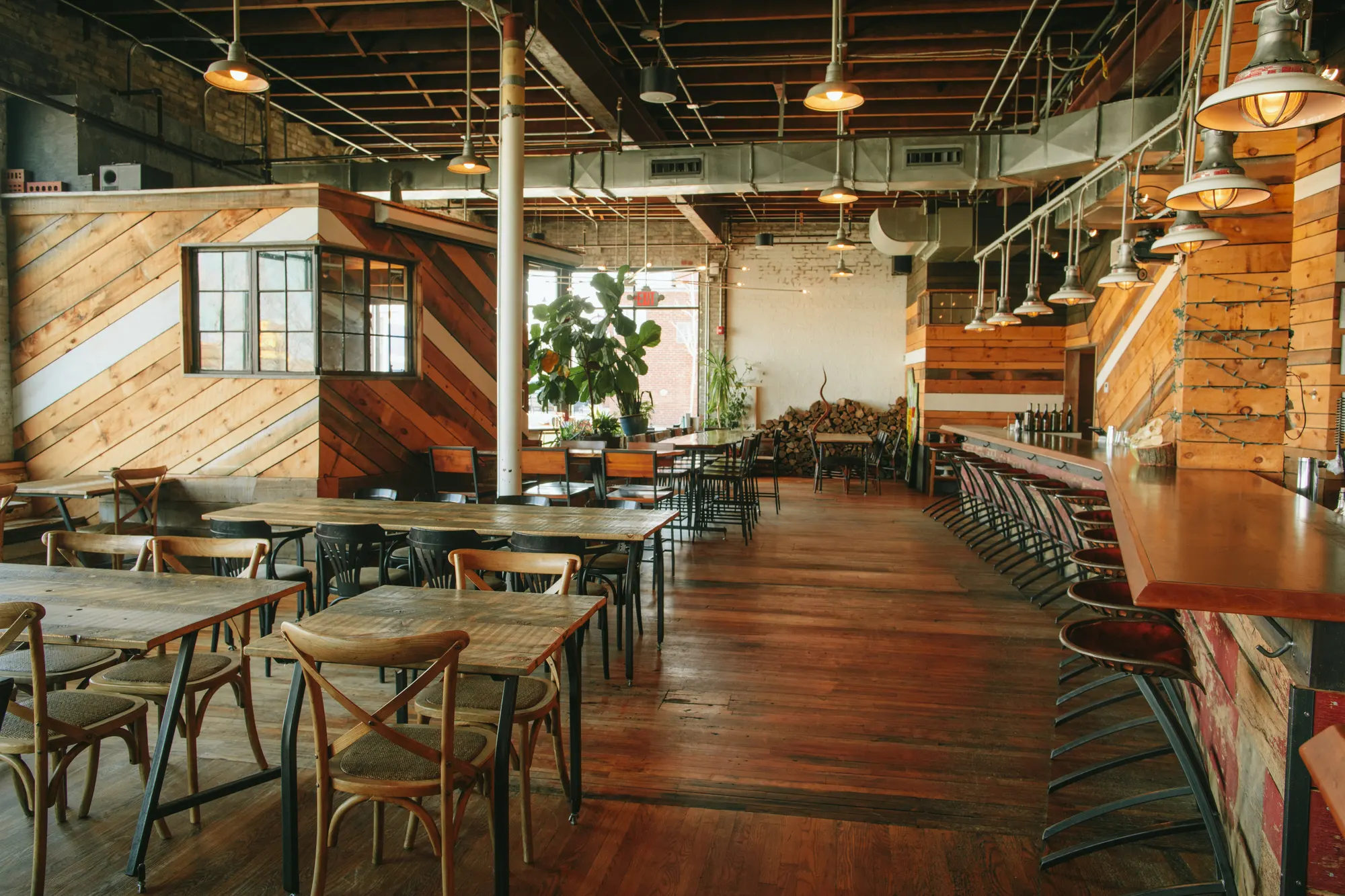 The dining room at La Brasa, diagonal timber cladding and communal tables
