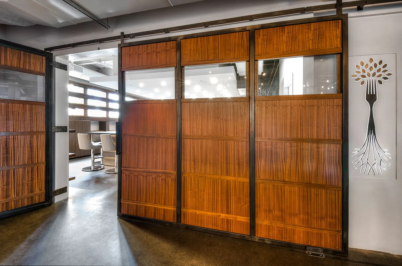 Timber barn doors on a track, closing the room from the building.