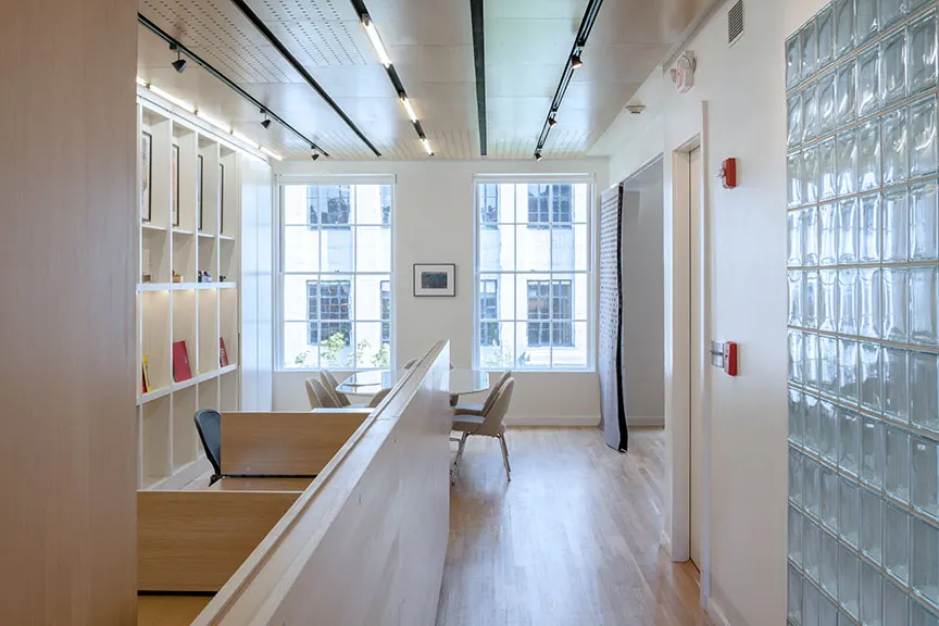 White shelving on one side, glass block on the other.