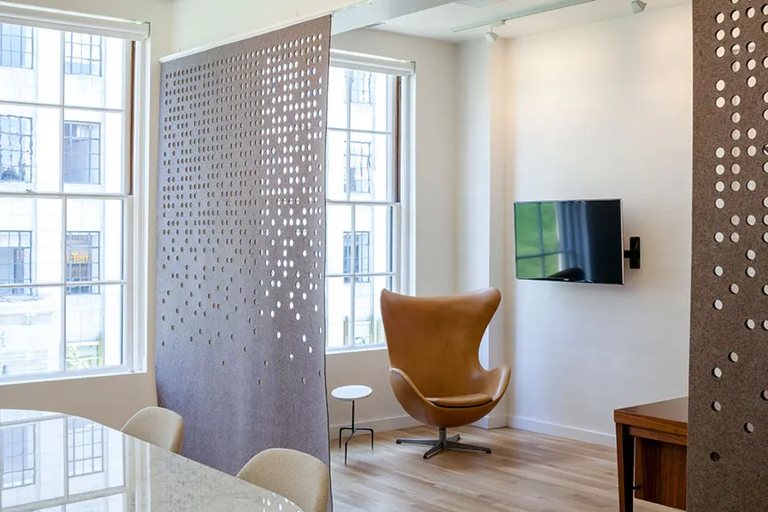 Perforated metal, so the next room is half visible through it.