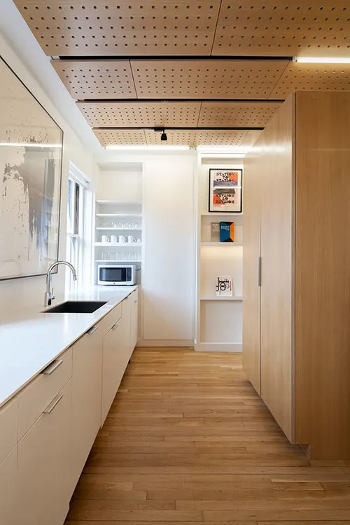 A narrow galley under a perforated ceiling.