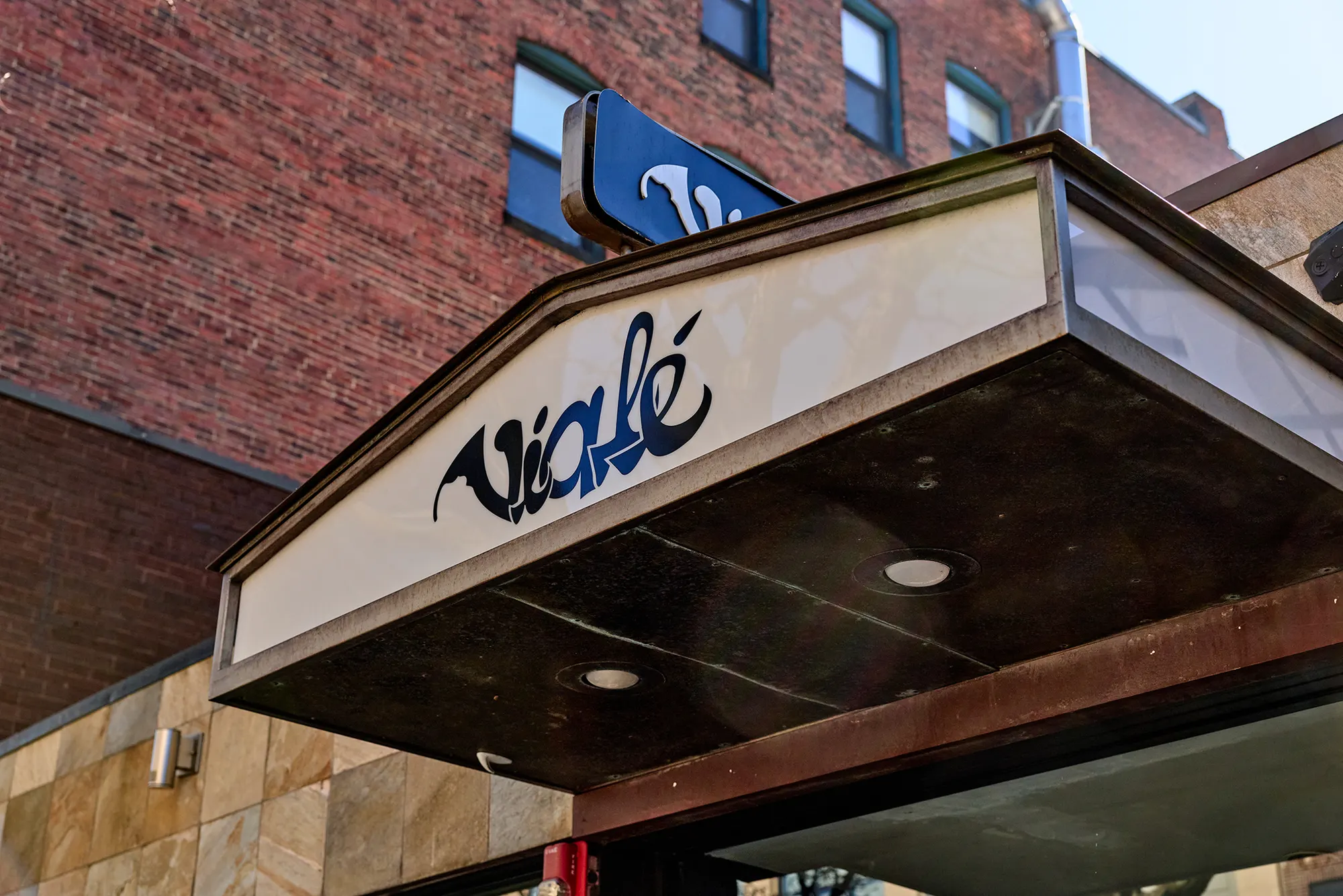 The restaurant's name on the entrance canopy, against brick.