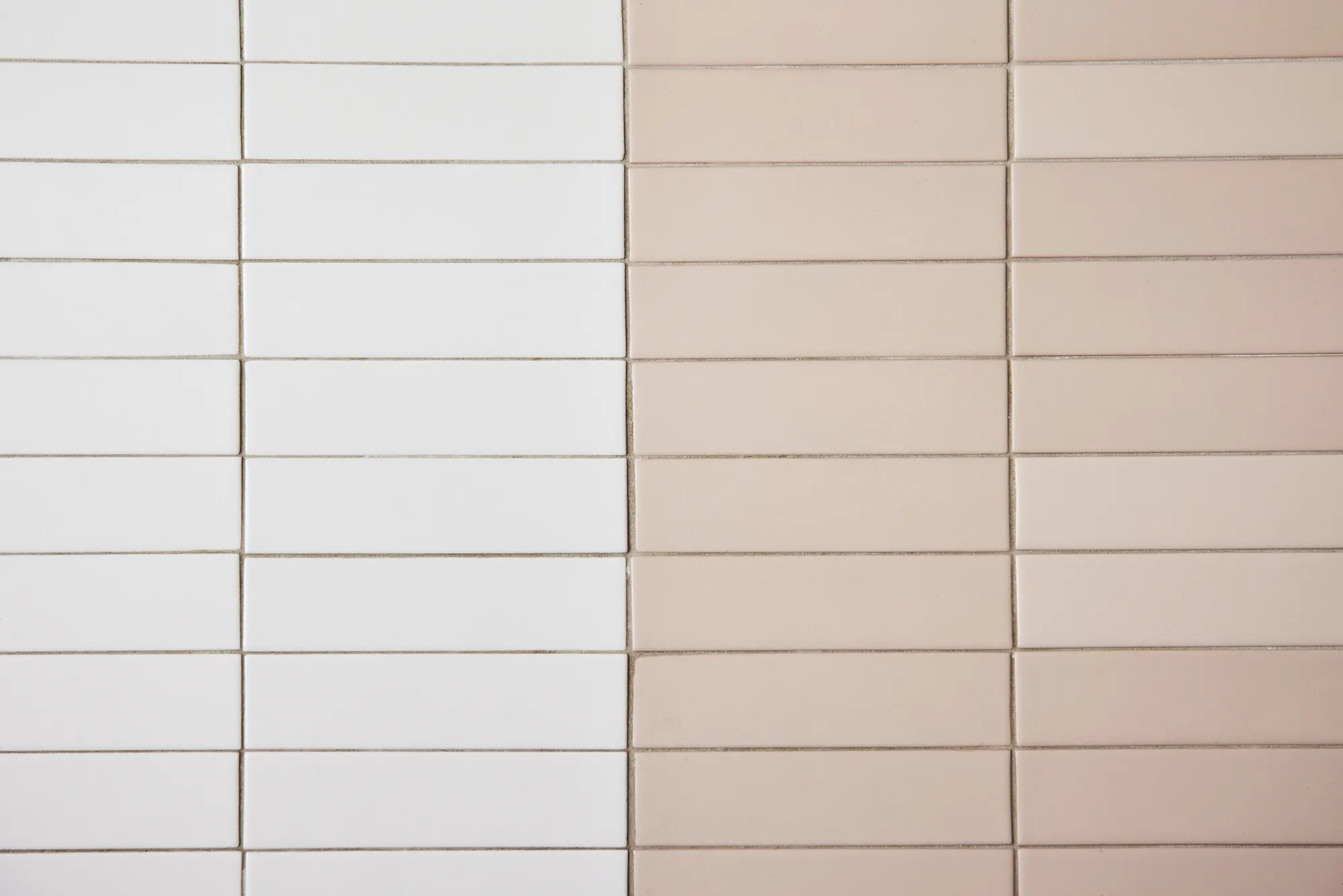 White and pink tile laid in long stacked rows.